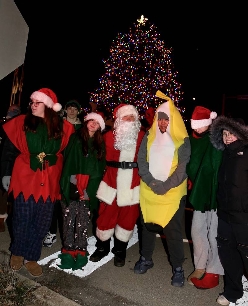 Santa poses with members of the Kaneland High School Key Club at the Sugar Grove Holiday Tree Lighting Ceremony on Friday, Dec. 6, 2024.