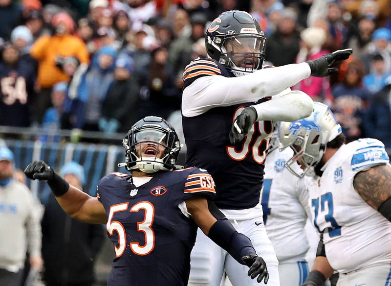 Chicago Bears linebacker T.J. Edwards (left) and Chicago Bears defensive end Montez Sweat celebrate after stopping the Detroit Lions on 4th and 1 late in the game Sunday, Dec. 10, 2023 at Soldier Field in Chicago.