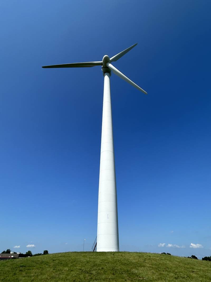 A single wind turbine sits next to the Erie Middle School in Erie on Friday, July 12, 2024..