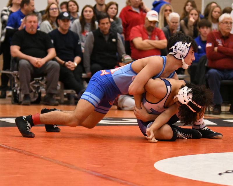 Marmion Academy Zach Stewart gets a hold of Mt. Prospect wrestler’s  in the 120 weight class where Zach took the win 19-3 during the first round of Friday’s Dec. 30th The Don Flavin wrestling Invite held at DeKalb High School.