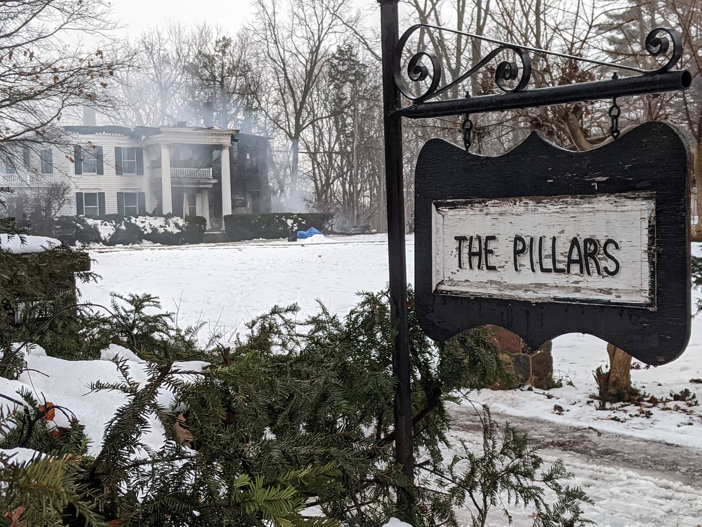 Firefighters remain on the scene at 407 Main St. near downtown Oswego. Built in the 1900s, the house is called The Pillars because of the 36 pillars located in and around the house.