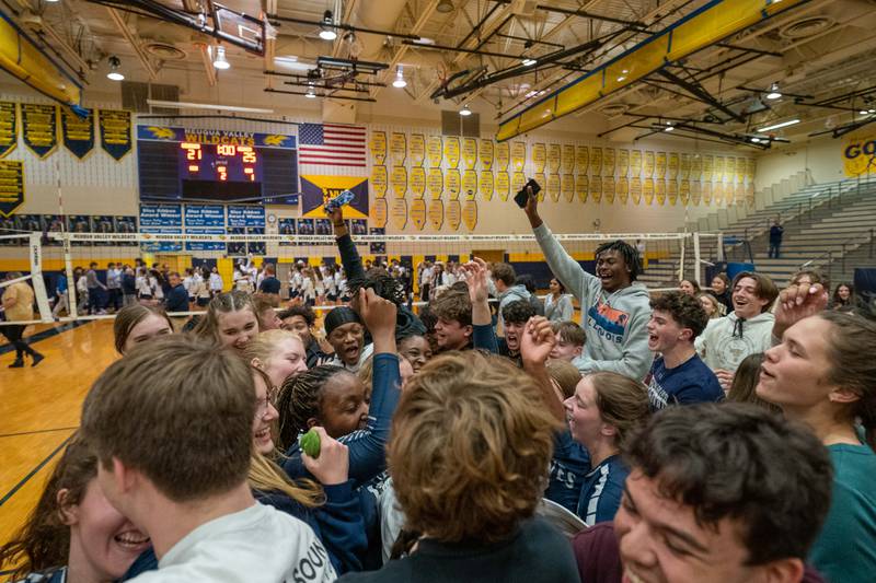 Oswego East fans storm the court in celebration after a victory over Neuqua Valley to win the Neuqua Valley 4A regional championship at Neuqua Valley High School in Naperville on Thursday, Oct 27, 2022.