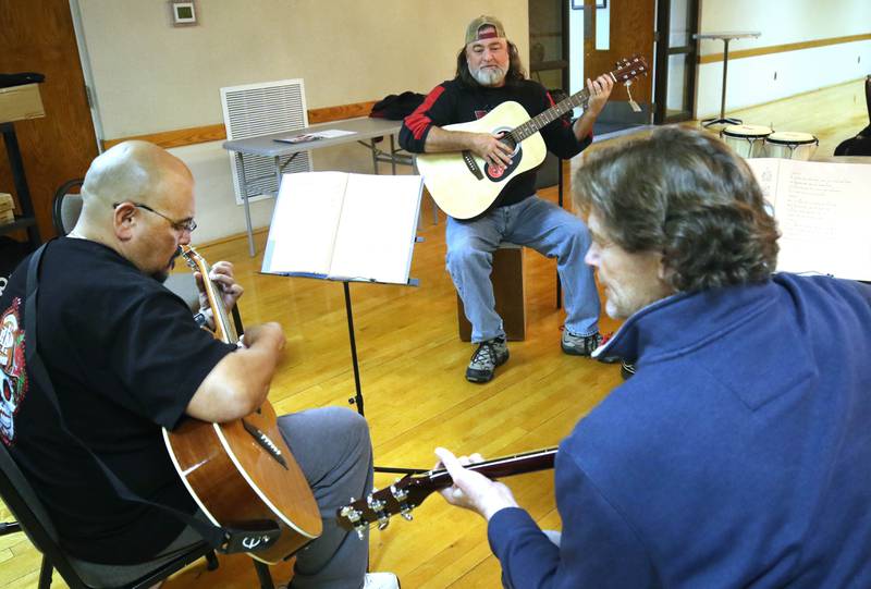 Veterans Manuel Olalde, (left) Rob McCann and Ron Lofton (right) play guitar Tuesday, Nov. 26, 2024 during the Kishwaukee Special Recreation Association’s Chords and Camaraderie at the Hopkins Park Community Center in DeKalb.