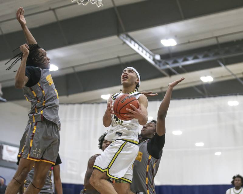 Yorkville Christian's Tray Alford (4) hangs in the air on a drive to the basket during their basketball game between Christ the King at Yorkville Christian, Feb 6, 2026 in Yorkville.