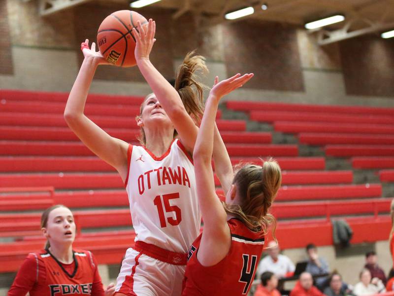 Ottawa's Hailey Larsen drives to the basket while being fouled by Yorkville's Macie Jones on Monday, Dec. 4, 2023 at Kingman Gym.