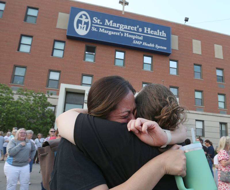 Joannie Janick hugs Gina Weatherspoon outside St. Margarets's Hospital for a gathering on Friday, June 16, 2023 in Spring Valley.