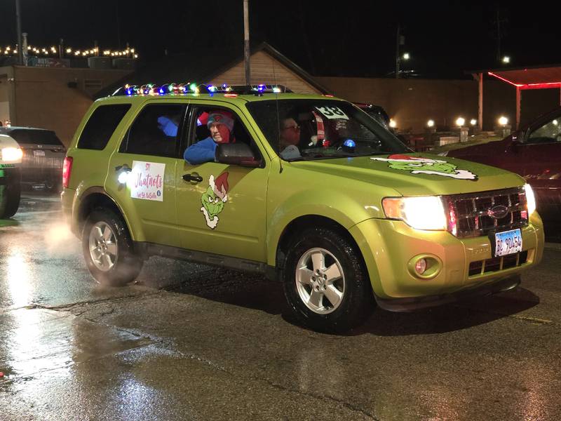 A Grinch mobile makes its way through the Winter Wonderland parade Saturday, Dec. 14, 2024, in Oglesby.