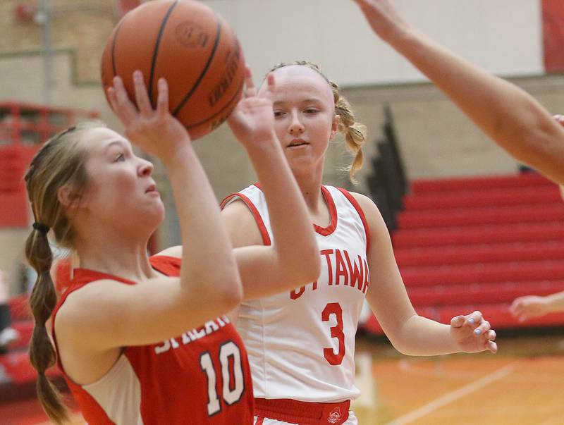 Streator's Ava Gwaltney dribbles in the lane as Ottawa's Skylar Dorsey defends during the Lady Pirate Holiday Tournament on Wednesday, Dec. 20, 2023 in Kingman Gym.