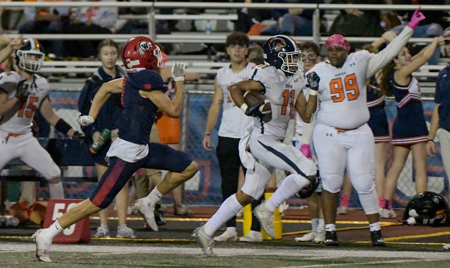 Oswego's Mark Melton (11) runs the ball West Aurora during a game in Aurora on Friday, October 8, 2021.
