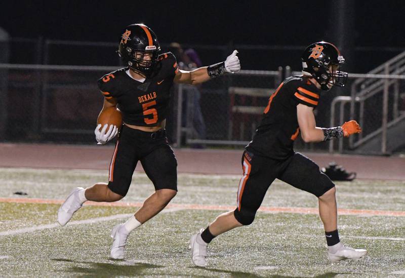 DeKalb's Toriano Tate (5) gains some yards on a punt return against Waubonsie during the first quarter in DeKalb on Friday, Oct. 1, 2021.