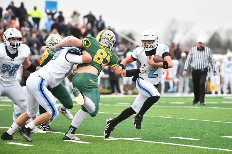 DePaul quarterback Fernando Rodriguez evades Coal City's Alec Waliczek on a run on Saturday, Nov. 23, 2024, during the Rams' 21-14 victory over the Coalers in the IHSA Class 4A Playoffs semifinal game.