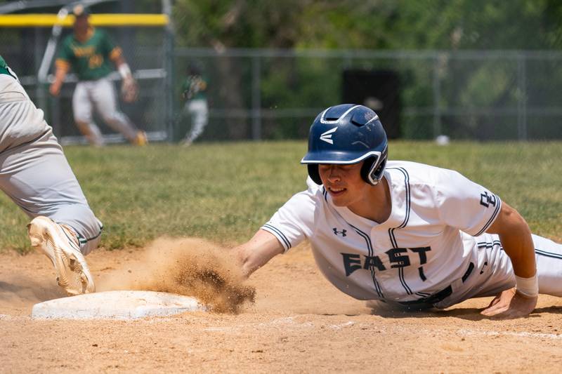 Oswego East's Michael Polubinski (1) dives back to first on a pick off attempt by Waubonsie Valley during the Class 4A Waubonsie Valley Regional final between Waubonsie Valley and Oswego Easy at Waubonsie Valley High School in Aurora on Saturday, May 27, 2023.