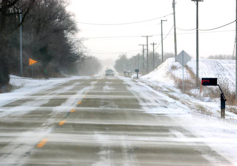 Powdery snow flies across Maple Street Friday morning near Marengo as bitter cold and heavy winds moved in following Thursday snowfall.