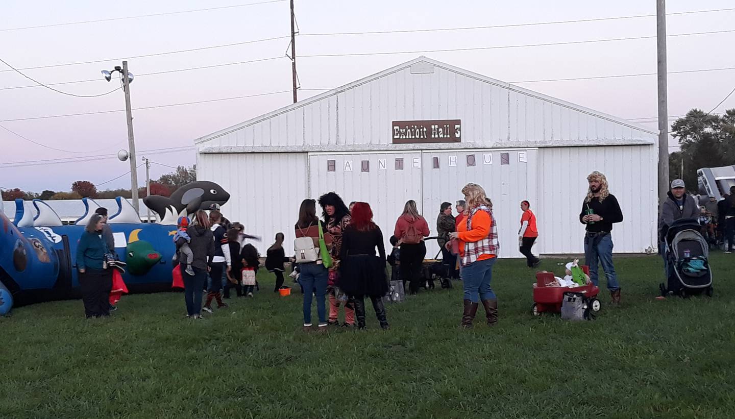 Families wait in line for an inflatable activity Saturday, Oct. 23, 2021, during Starved Rock Regional Center's trunk-or-treat event at the La Salle County 4-H Fairgrounds in Ottawa.