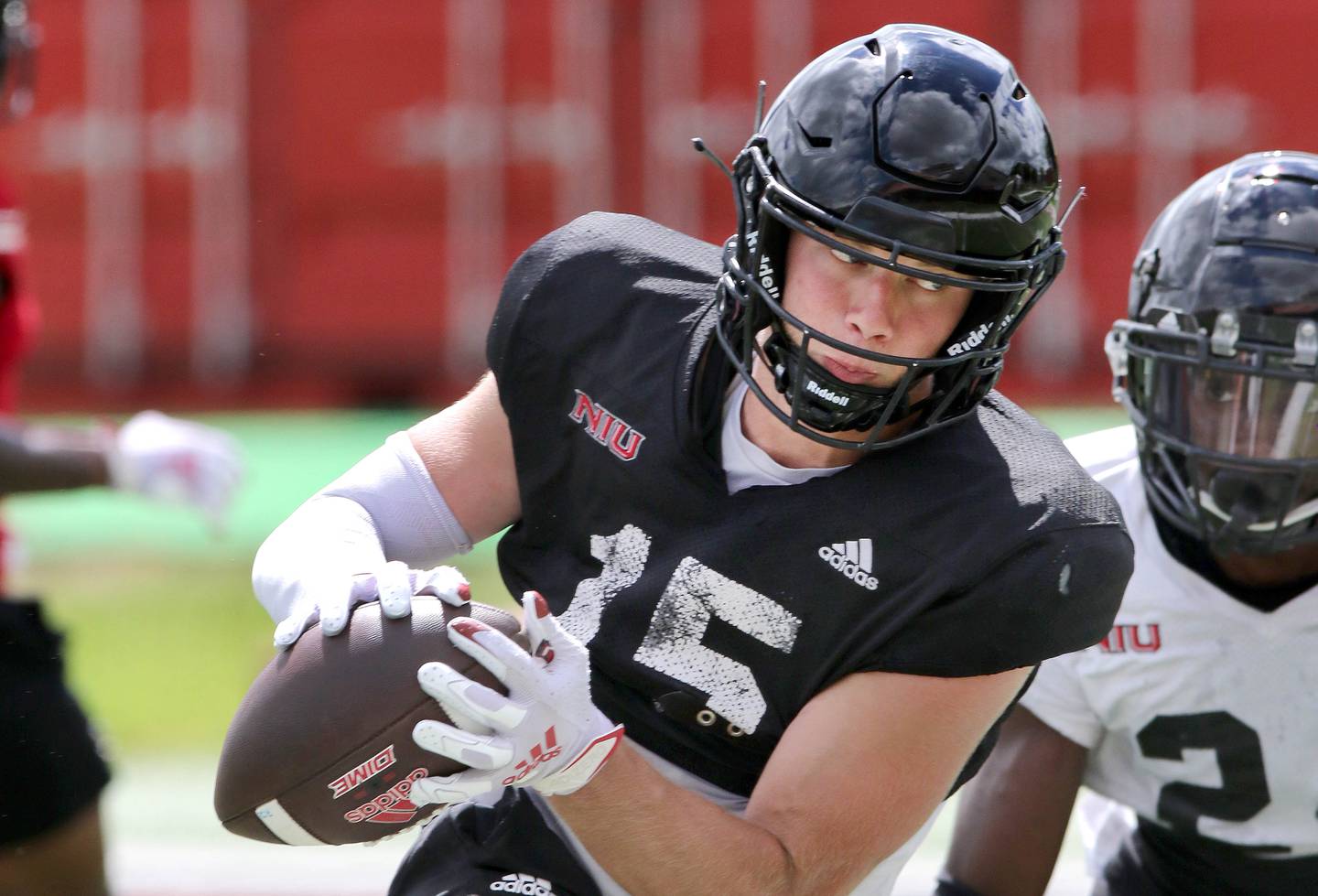 Northern Illinois Huskies receiver Cole Tucker makes a catch in front of safety Jashon Prophete Tuesday, Aug. 9, 2022, during practice in Huskie Stadium at NIU.