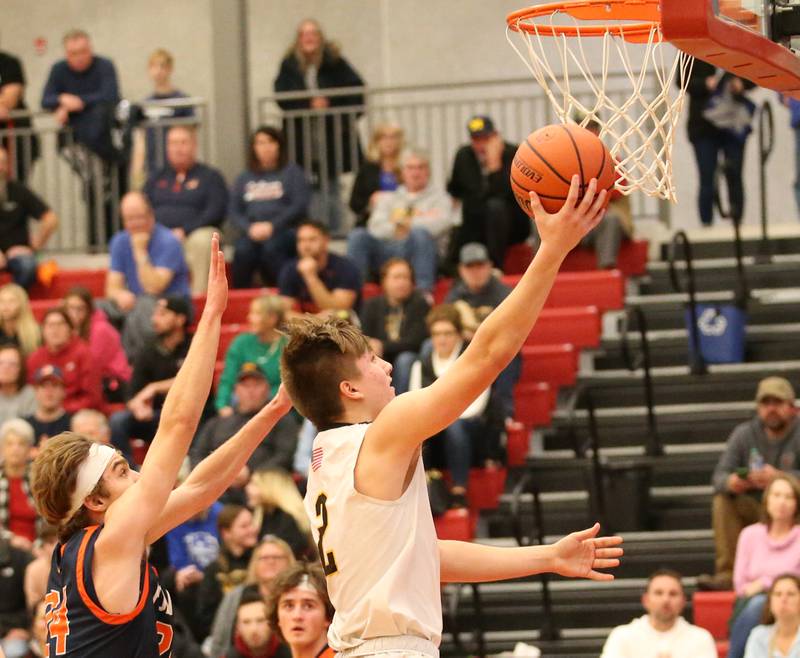 Putnam County's Andrew Pyszka (left) runs in the lane past Pontiac's Keer Bauman (left) during the Colmone Classic tournament on Friday, Dec. 9, 2022 at Hall High School in Spring Valley.