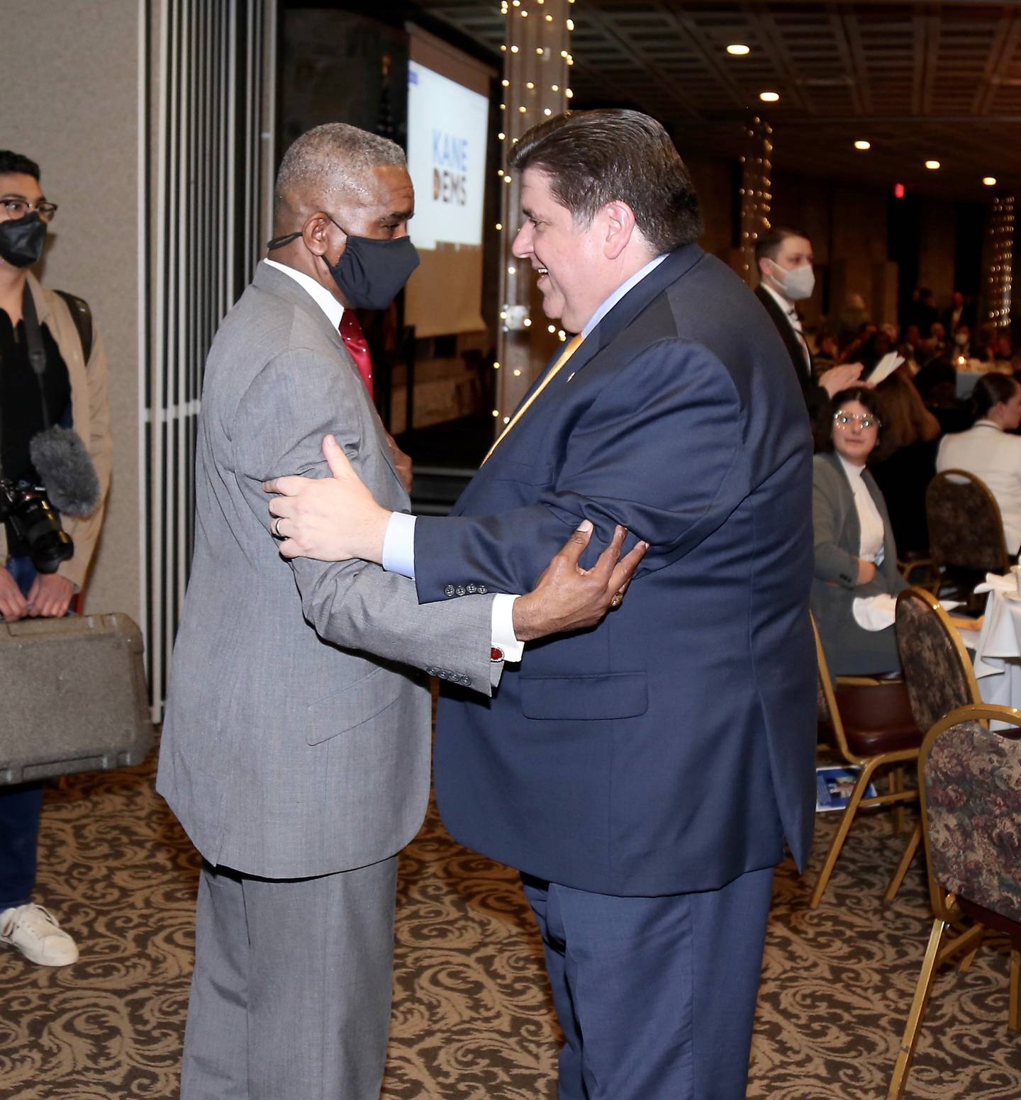 Chicago Alderman David Moore greets Governor JB Pritzker during the Truman Dinner in Aurora on Sunday, Feb. 27, 2022.