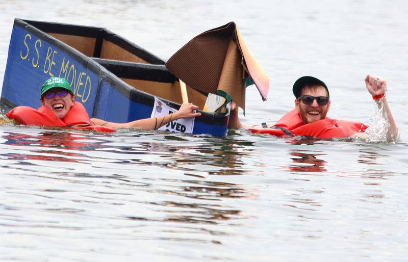 Chris Dumas, right, of Crystal Lake and his sister Kelley Edwards celebrate the sinking of their craft S.S. Be Moved during the Cardboard Regatta on Crystal Lake Saturday.