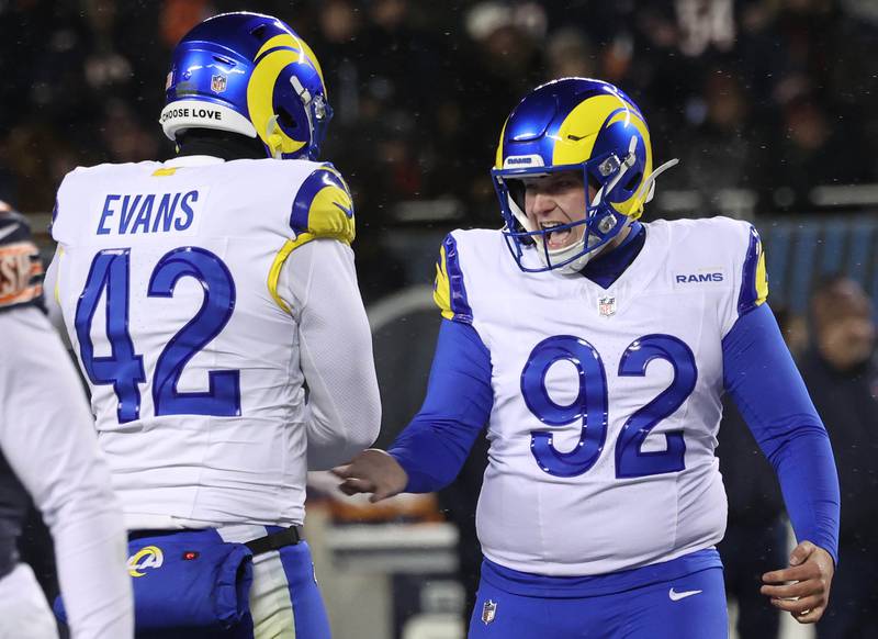 Los Angeles Rams place kicker Harrison Mevis is congratulated by holder Ethan Evans after his game winning kick Sunday, Jan. 18, 2026, during their NFC divisional playoff matchup against the Chicago Bears at Soldier Field in Chicago.