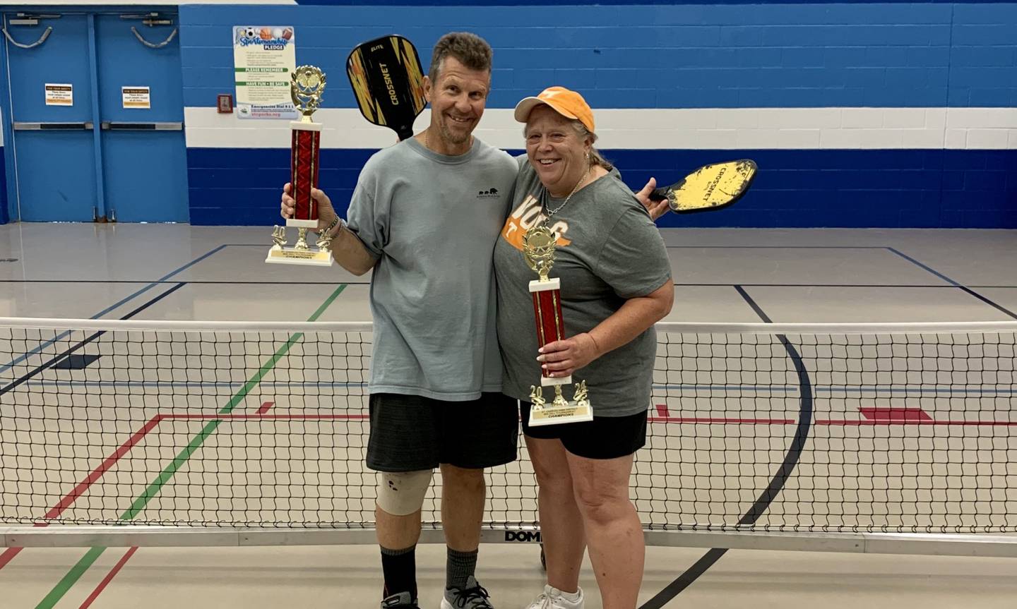 Pickleball tournament winners Lane and Bernee Gredzileski pose with their trophies at the Pickle Paradise event on June 21, 2024, in the Pottawatomie Community Center in St. Charles.