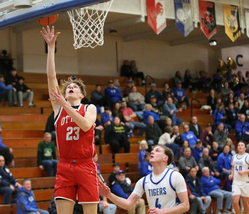 Ottawa's Owen Sanders scores on a layup over Princeton's Korte Lawson on Monday, Feb. 5, 2024 at Prouty Gym.