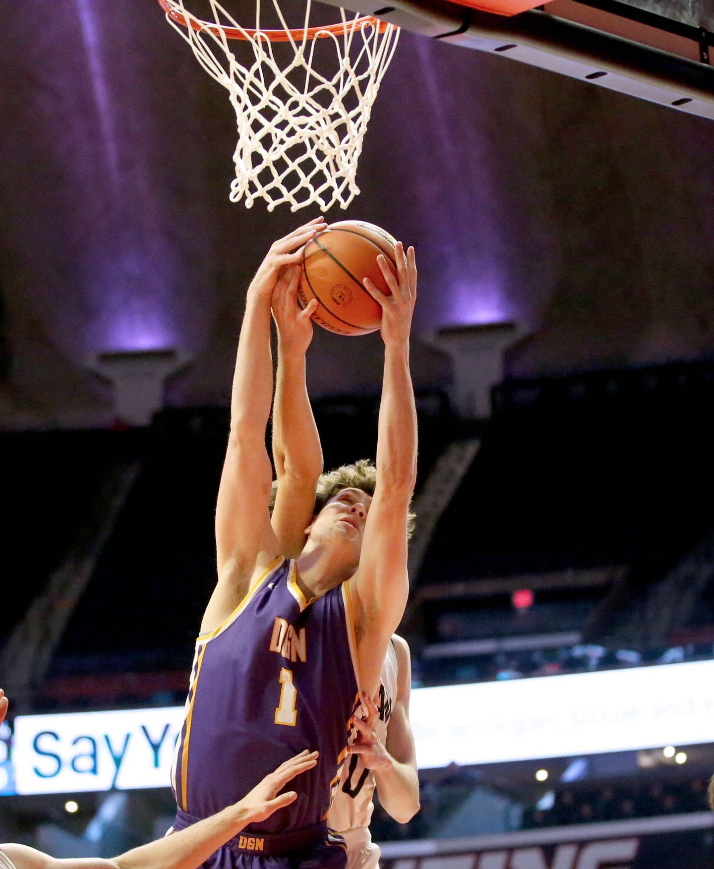 Downers Grove North's Jake Riemer grabs a rebound over New Trier's Tyler Van Gorp in the Class 4A state third place game on Friday, March 10, 2023 at the State Farm Center in Champaign.