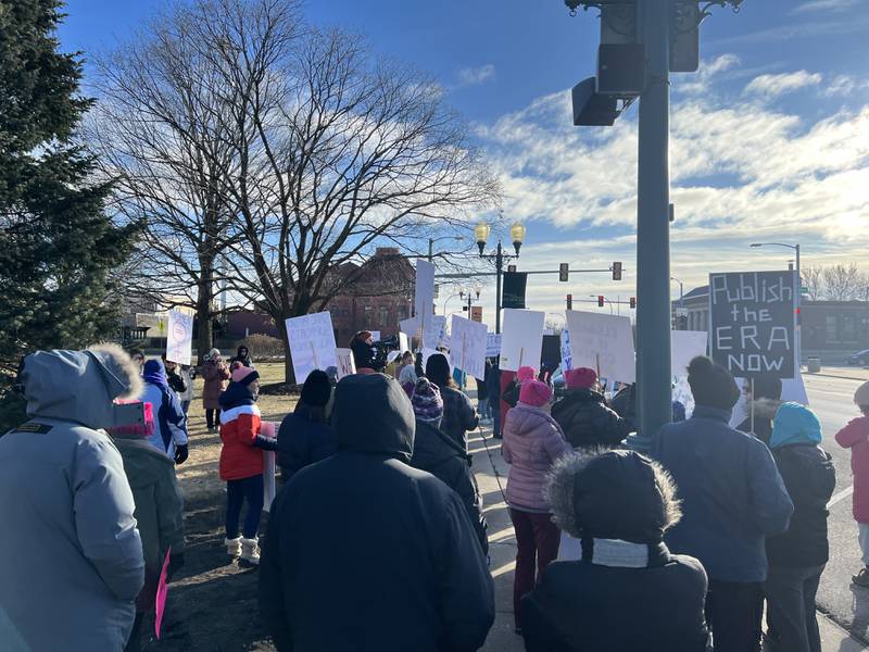 Facing subfreezing temperatures, dozens of women and a handful of men attend a women's rights march on Saturday, Jan. 18, 2025, on the sidewalks in front of the DeKalb County Courthouse in downtown Sycamore. The DeKalb County march was held on the same day as the national women's march organized in Washington, D.C. days before Donald Trump's second presidential inauguration.