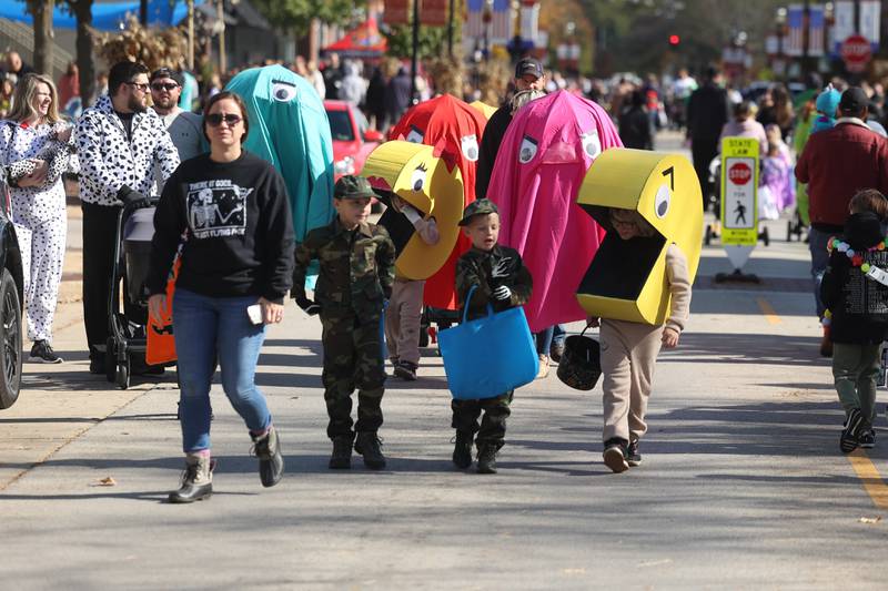 A Pac-man family walks along West Lockport Street at the annual Halloween Spooktacular in downtown Plainfield on Saturday, Oct. 28, 2023.