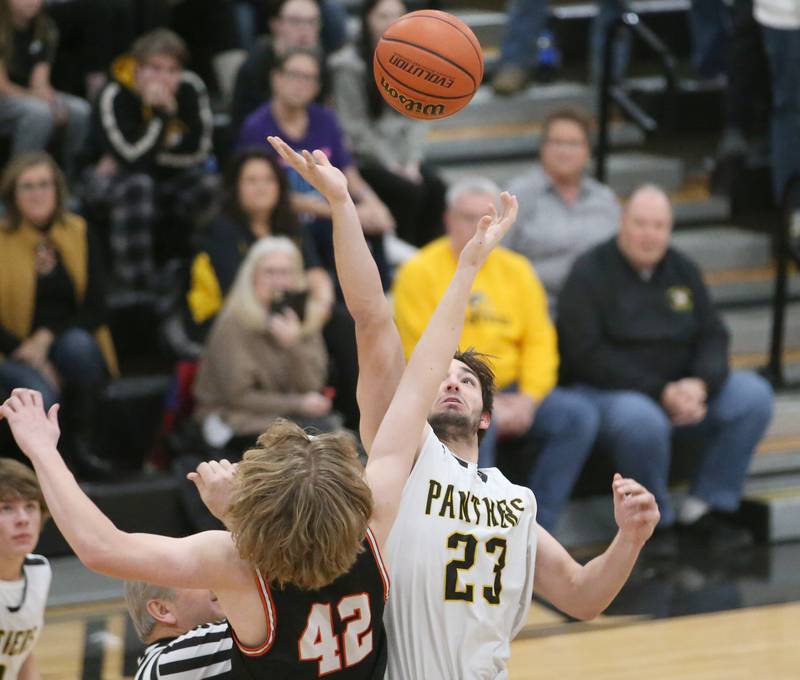 Putnam County's Jackson McDonald wins the opening tip over Roanoke-Benson's Zeke Kearfott during the Tri-County Conference Tournament on Tuesday, Jan. 24, 2023 at Putnam County High School.