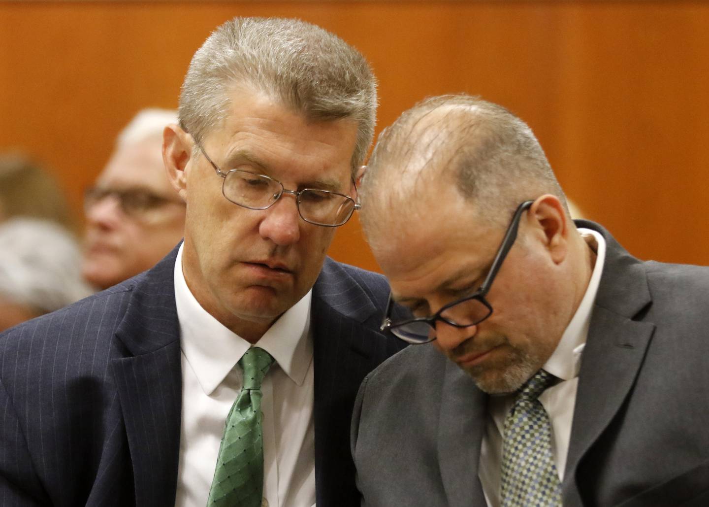 Defense attorney Matthew McQuaid talks with his client Andrew Polovin during his trial before Lake County Judge George Strickland on Monday, Sept. 11, 2023, in the McHenry County courthouse.  Two former Illinois Department of Children and Family Services employees Carlos Acosta, 57, of Woodstock, and Andrew Polovin, 51, of Island Lake, are each charged with two counts of endangering the life of a child and health of a minor, Class 3 felonies, and one count of reckless conduct, a Class 4 felony, related to their handling of the AJ Freund case.