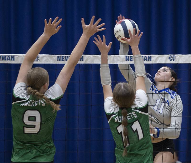 Newman’s Isabella Lanning plays the ball against Rock Falls’ Kayla Hackbarth (left) and Miley Bickett Monday, Oct. 28, 2024, during regional play at Newman.