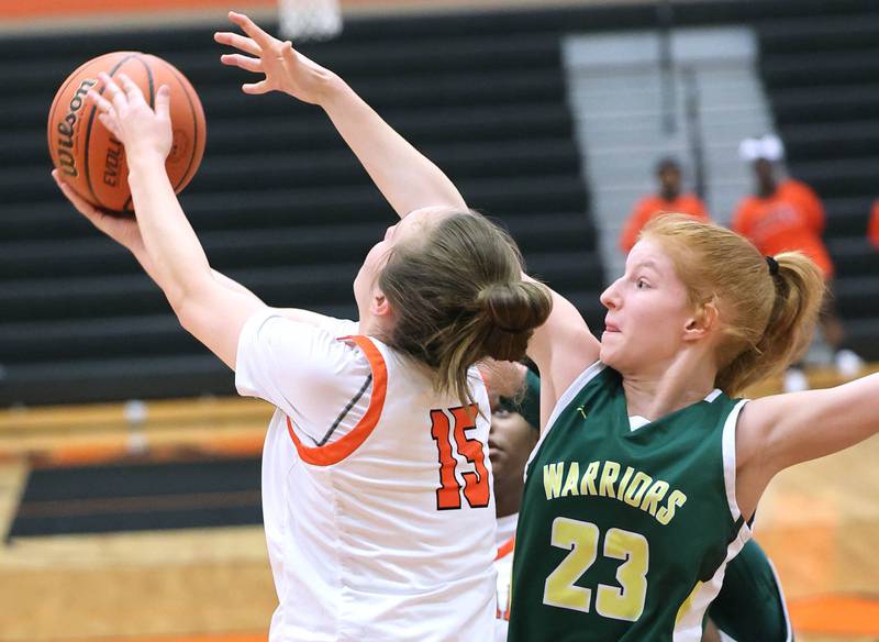 Waubonsie Valley's Lily Newton tries to block the shot of DeKalb's Kailey Porter during their game Thursday, Dec. 15, 2022, at DeKalb High School.