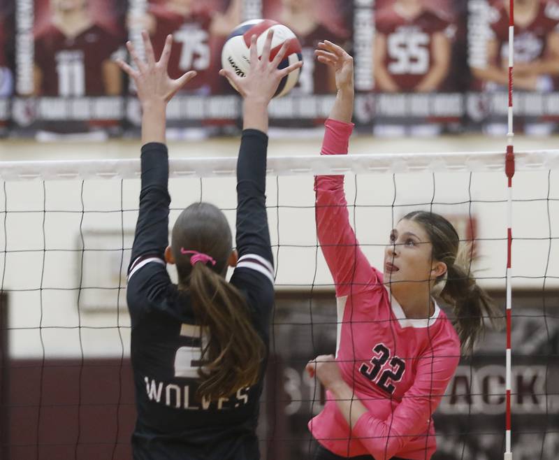 Huntley's Izzy Whitehouse (right) hits the ball past the block of Prairie Ridge's Addison Smith during a Fox Valley Conference volleyball match on Tuesday, Oct. 14, 2025, at the Prairie Ridge High School in Crystal Lake.
