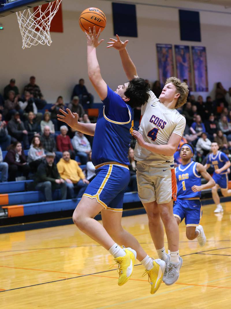 Aurora Central Catholic's Braden Dillon gets a layup in front of Genoa-Kingston's Cody Cravatta Monday, Feb. 23, 2026, during their IHSA Class 2A regional quarterfinal at Genoa-Kingston High School.
