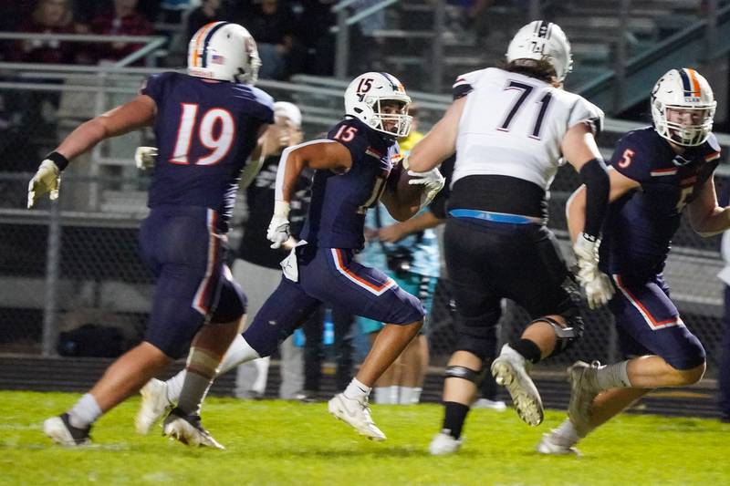 Oswego’s Donovan Williams (15) runs back an interception for a touchdown against Plainfield North during a football game at Oswego High School on Friday, Sept. 27, 2024.