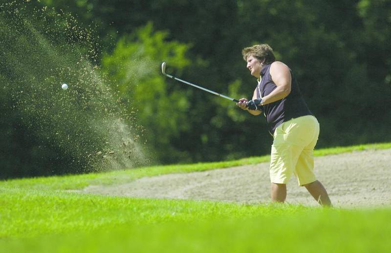 Cheri Russell blasts her way out of the sand trap on the 18th hole to finish out her championship in Sunday's IVWG Open at Senica's Oak Ridge Golf Course in LaSalle.