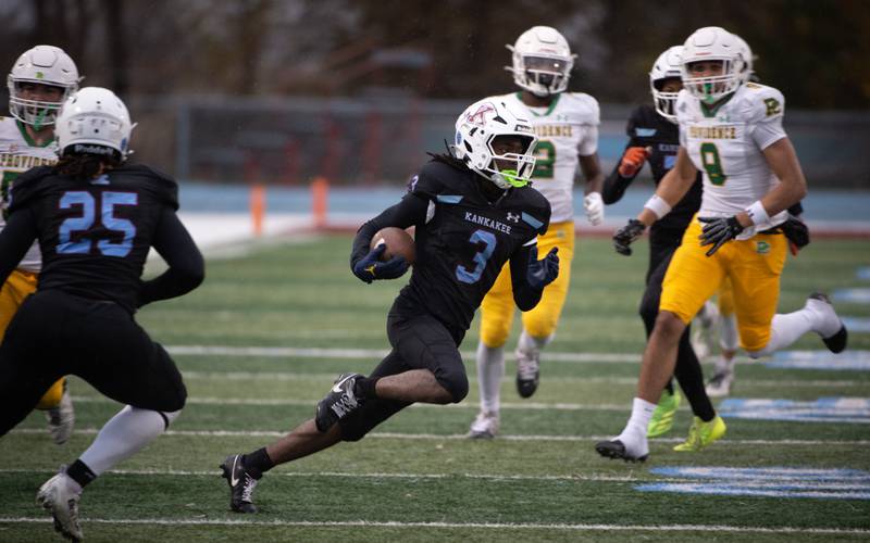 Kankakee's Cedric Terrell carries the ball after an interception in the first half of a Class 5A playoff against Providence Catholic on Saturday, November 8, 2025.