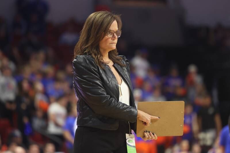 IC Catholic head coach Nancy Kerrigan signals in a play against Genoa-Kingston in the Class 2A championship match on Saturday in Normal.