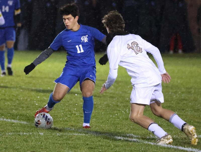 Burlington Central’s Niko Guzman (left) tries to work the ball past Sycamore's Maddux McLaughlin Tuesday, Oct. 21, 2025, during their IHSA Class 2A regional semifinal match at Burlington Central High School.