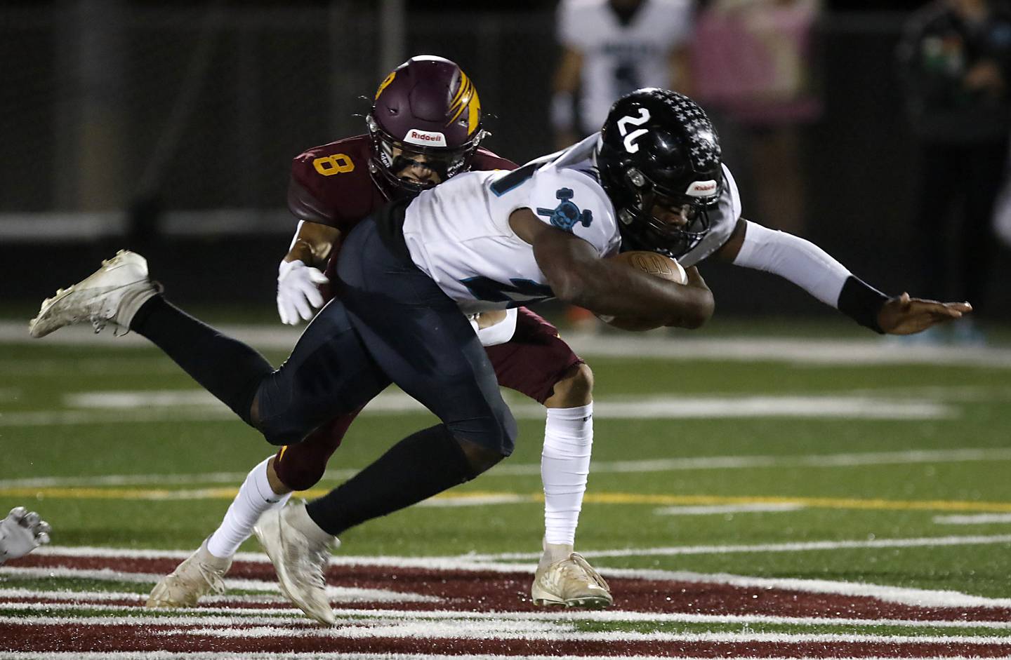 Woodstock North's David Randecker tries to break the tackle of Richmond-Burton's Joseph Larsen during a Kishwaukee River Conference football game on Friday, Oct. 11, 2024, at Richmond-Burton High School.