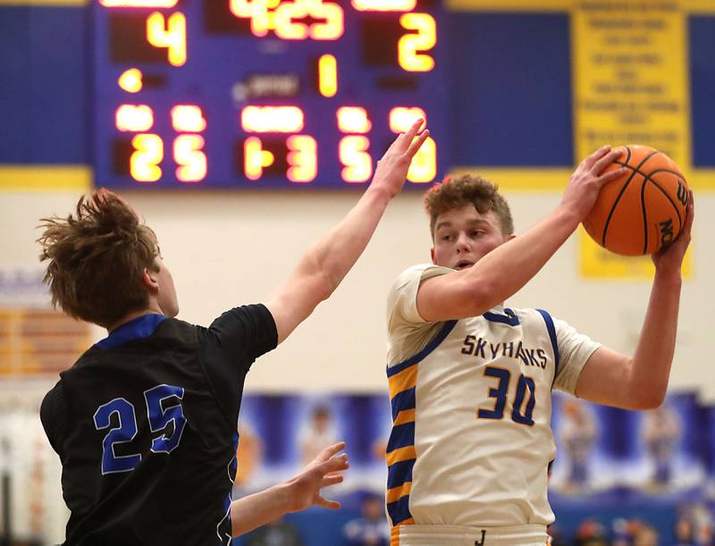 Johnsburg's Jayce Schmitt grabs a rebound in front of Woodstock's Liam Laidig during a Kishwaukee River Conference boys basketball game on Friday, February. 13, 2026, at Johnsburg High School.