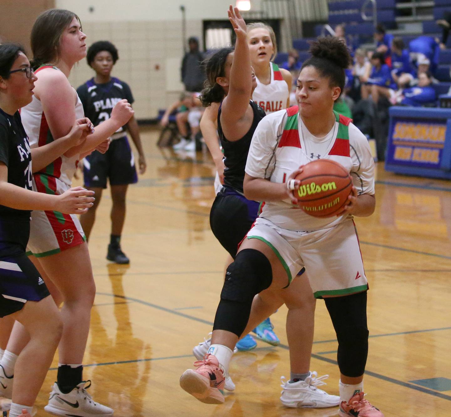 L-P's Jasmine Garman (24) spins sround Plano's Ryssa Woodhouse (3) to grab a rebound during the Tim Humes Breakout Tournament on Friday, Nov. 18, 2022 in Somonauk.