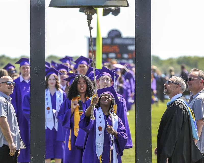 Sanai Young rings the bell before leaving the field after the Plano High School Graduation ceremony Sunday, May 18, 2025 in Plano.