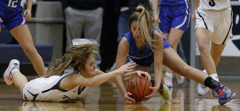 Cary-Grove's Sam Skerl battles with Burlington Central's Samantha Origel for a loose ball during a Fox Valley Conference girls basketball game Friday Jan. 6, 2023, at Cary-Grove High School in Cary.