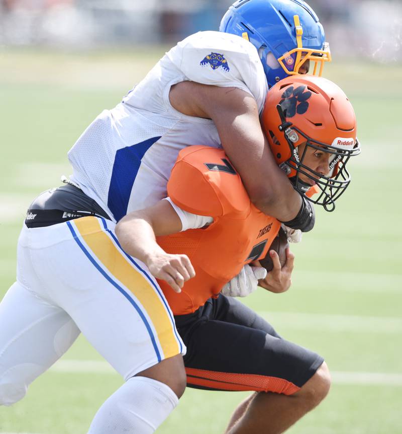 Joe Lewnard/jlewnard@dailyherald.com
Wheaton Warrenville South’s Brahm Rozanski, right, gets tackled by Simeon’s Khye J. Brown during Saturday’s game in Wheaton.