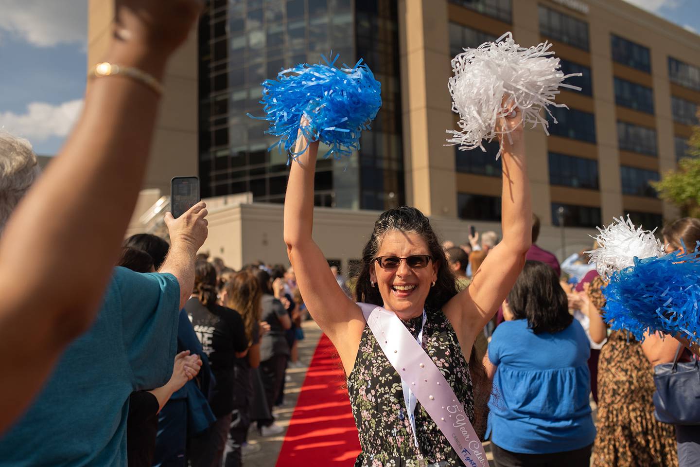 The event included a red-carpet walk, where each survivor was met with applause and cheers from family and friends, staff, and fellow survivors.