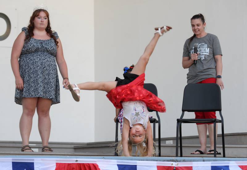Aniyah Eggleston, 4, does a cartwheel in the talent portion of Let Freedom Ring's Little Miss and Mister Firecracker contest on Wednesday, July 2, 2025. Watching are contest officials Heidi Nicholson and Abi Fletcher, the 2024 Let Freedom Ring Queen.