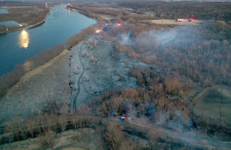 Smoke and charred timber burns from a large brush fire that broke out near the 12000 block of West Bottom Road on Monday, March 2, 2025 near Granville. The fire was elevated to the second alarm as the flames spread further west. Over 150 acres of timber burned along the Illinois River during the incident.