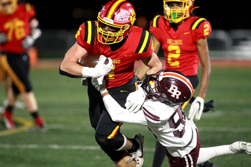 Batavia’s Charlie Whelpley carries the ball during a Class 7A round 1 playoff game against Brother Rice in Batavia on Friday, Oct. 27, 2023.