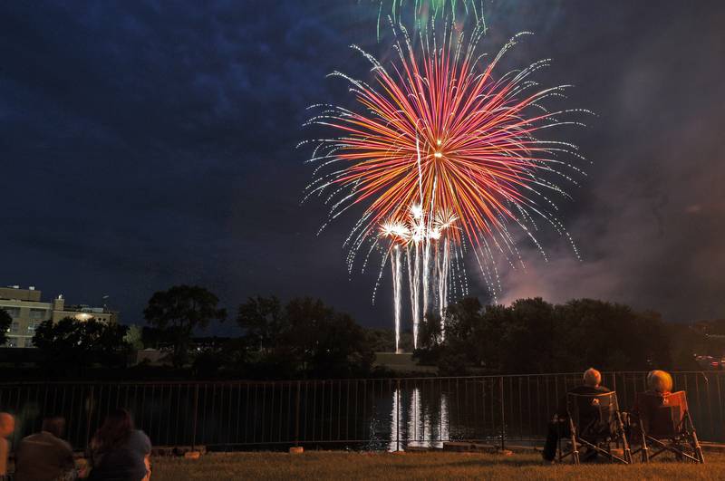 The Ottawa First-sponsored fireworks reflect Friday, July 9, 2021, over the Fox River from the Ottawa Boat Club.